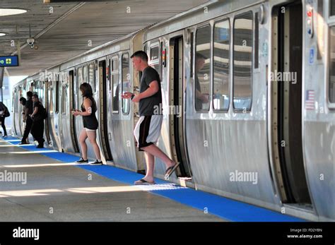 Passengers Disembark From A Cta Blue Line Rapid Transit Train At