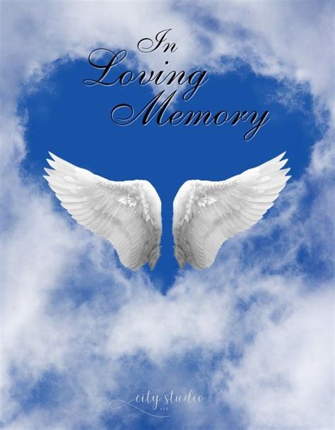 Two White Angel Wings With The Words In Loving Memory Above Them On A