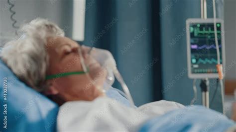 Hospital Ward Portrait Of Beautiful Elderly Woman Wearing Oxygen Mask Sleeping In Bed Fully