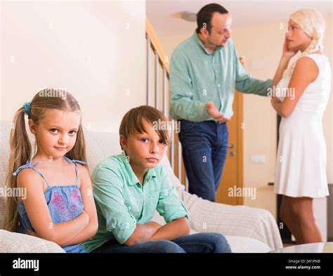 Sad European Children In Silence While Parents Arguing At Home Stock
