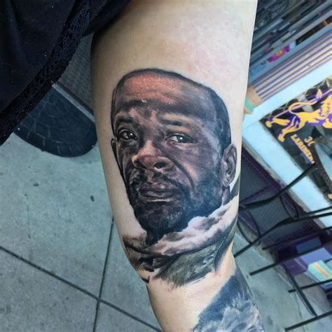 A Man S Arm With A Portrait Of Him On It