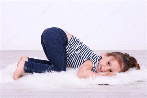 Beautiful Small Girl Lying Floor Wall Background Stock Photo By