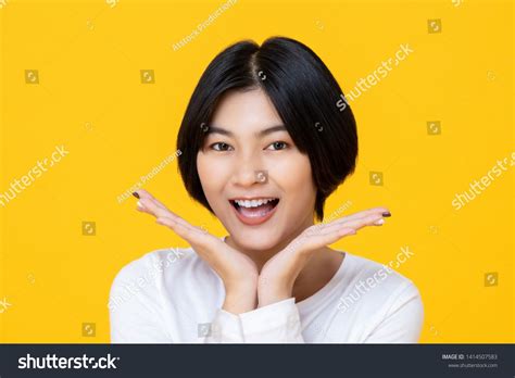 Cheerful Friendly Short Hair Asian Woman Smiling With Her Very Clean White Teeth And Placing Her