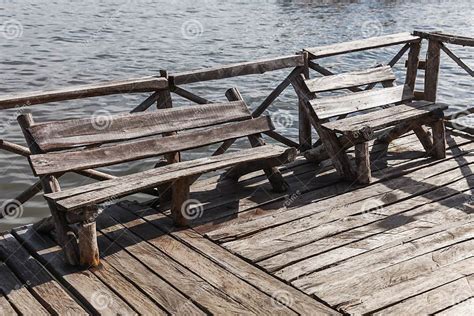 Old Wooden Benches Stand At The End Of A Pier Stock Image Image Of