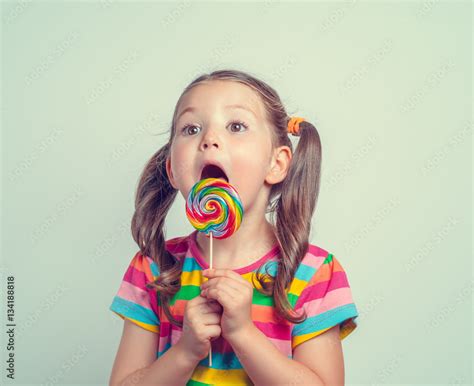 Beautiful Cute Little Girl Eating Lollipop Foto De Stock Adobe Stock