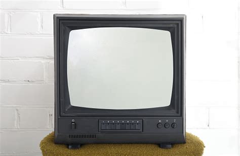 Old Black Vintage Tv Set Against A Brick Wall From The 1980s 1990s