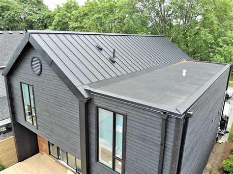 Standing Seam Metal Roof And Façade And Flat Roof With Parapets