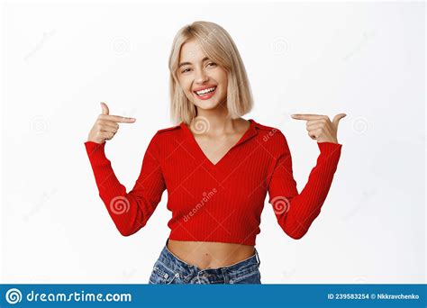 Portrait Of Attractive Blond Female Model In Stylish Casual Clothes Pointing Fingers At Herself