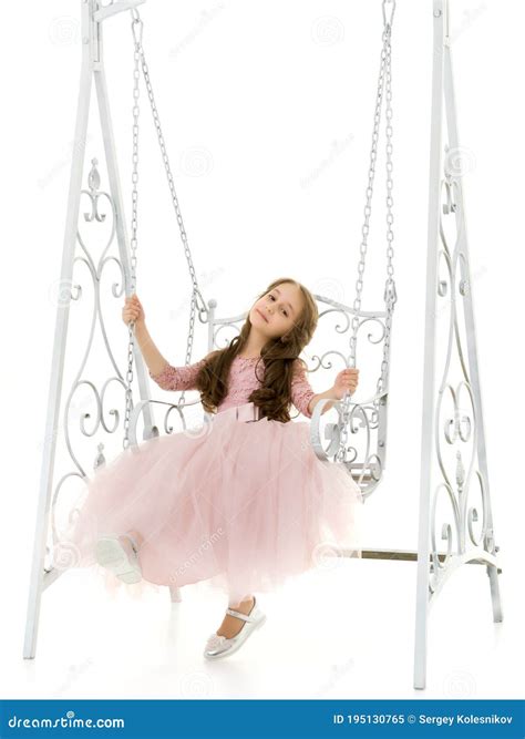 Charming Long Haired Girl In Nice Dress Swinging On Elegant Swing