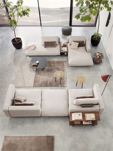 A Living Room Filled With Lots Of Furniture Next To A Large Glass