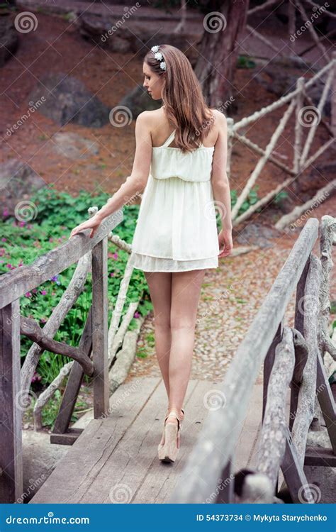 Beautiful Woman With Long Legs Wearing White Dress Walking At The