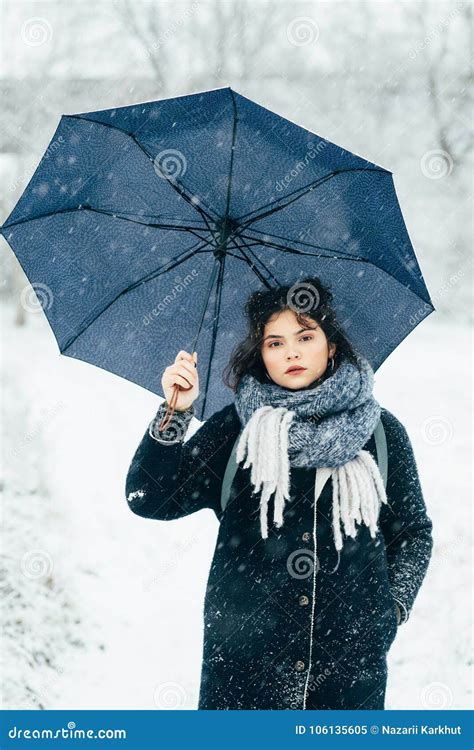 A Cute Young Girl Holds Umbrellas In The Hands Of The Winter Season