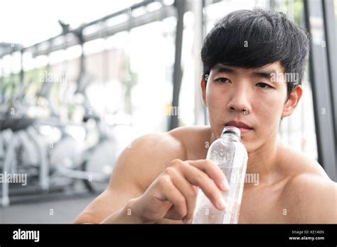 Young Man Drinking Water In Fitness Center Male Athlete Feeling