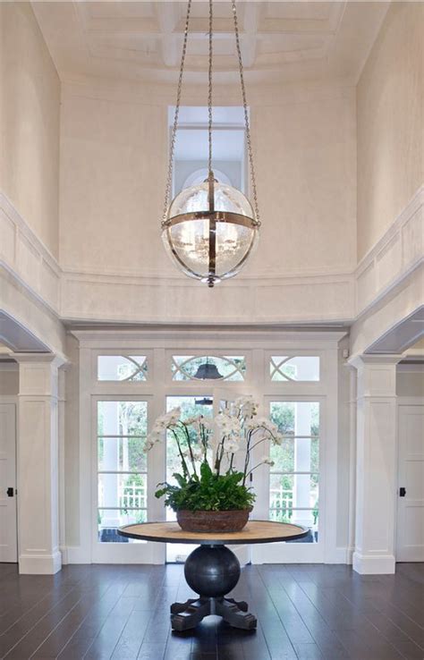 Large Two Story Entry With Round Table And Painted Architectural