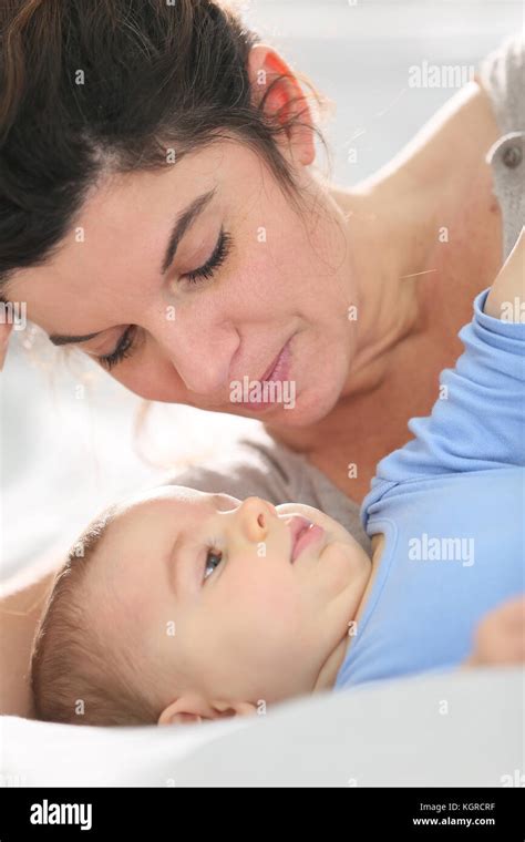 Portrait Of Mother Cuddling Baby Boy Stock Photo Alamy
