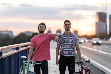 Portrait Of Two Handsome Caucasian Gay Men Going On A Bicycle Ride