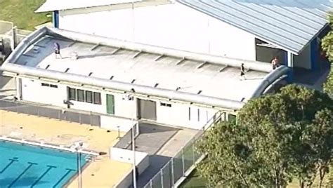 photo 3 inmates on a roof of brisbane youth detention centre australia facility is on