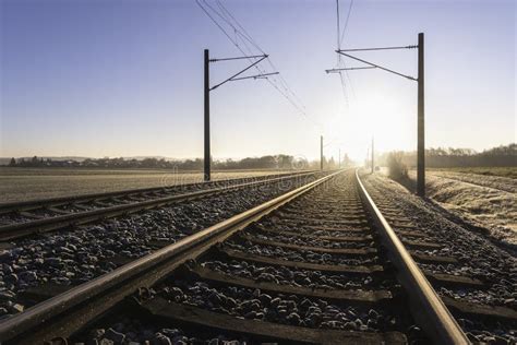 Railroad Tracks And Frosty Landscape Rail Tracks At Sunrise Stock