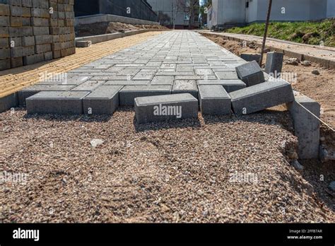 Laying Gray Concrete Paving Slabs In A House Walkway Process Of