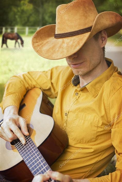Handsome Man In Cowboy Hat Playing Guitar — Stock Photo © Geraktv 77382936