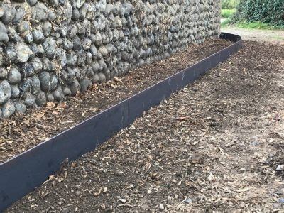 You can cut a bunch of wood boards and insert them into the ground around the lawn or around the flower beds to. Lawn Edging | Norfolk Estate Fencing