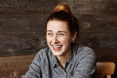 Stylish Young Redhead Woman Wearing Grey Checkered Shirt Laughing Out