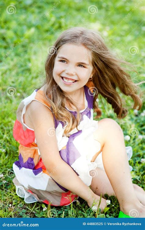 Happy Little Girl Is Sitting On The Grass Stock Image Image Of