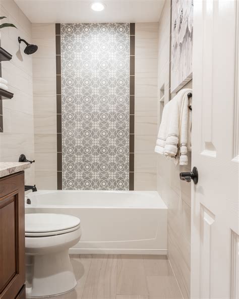 Looking for some bathroom tile ideas? The shower wall features a center panel with accent tiles ...