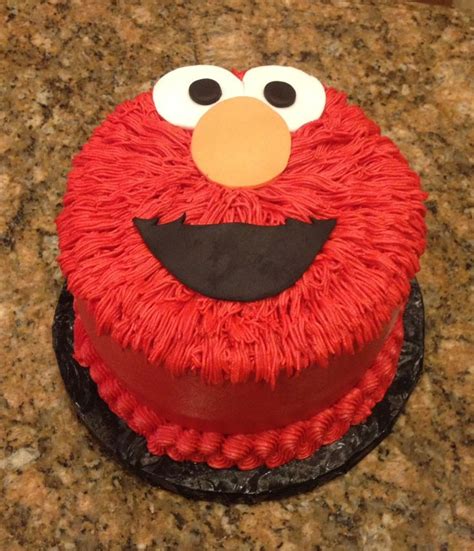 A Red Cake With Black Icing And A Sesame Street Character On The Top Is