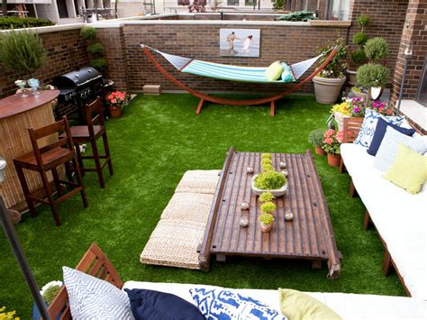 Modern backyard seating area with hidden lighting. Enclosed Patio With Astroturf & Outdoor Bar | HGTV
