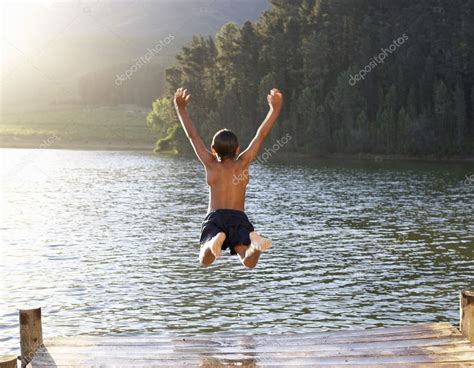 Young Boy Jumping Into Lake Stock Photo By ©monkeybusiness 11886107