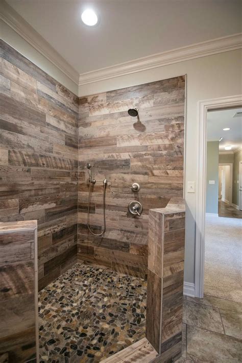 Another clever optical illusion to make a room feel bigger is to run tiles from the floor all the way up to. Tile for master shower. | Rustic bathroom shower, Rustic ...