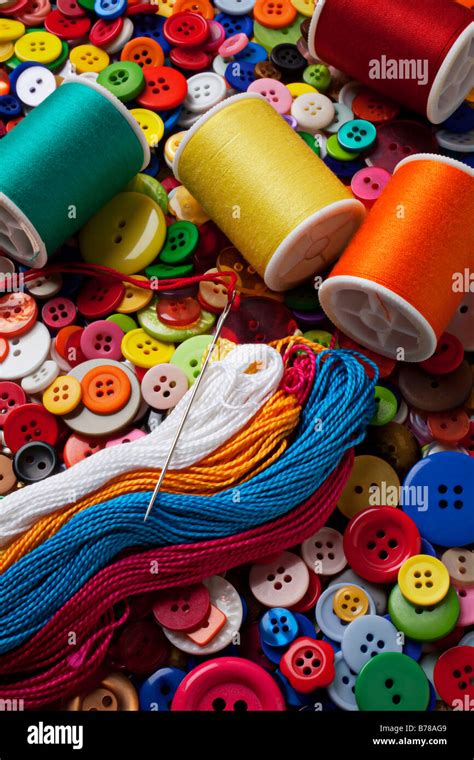 Spools Of Thread And Buttons With Needle Stock Photo Alamy