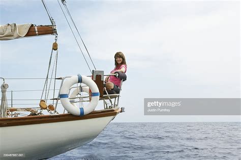 Young Woman Relaxing At Back Of Sailboat Smiling Portrait High Res