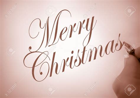 person writing merry christmas in calligraphy in sepia  Merry