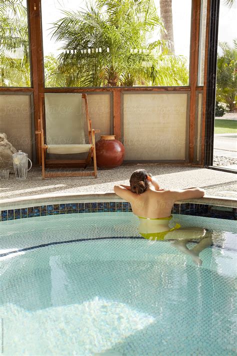 Beautiful Hispanic Woman Relaxing In Pool At Hot Springs By Stocksy