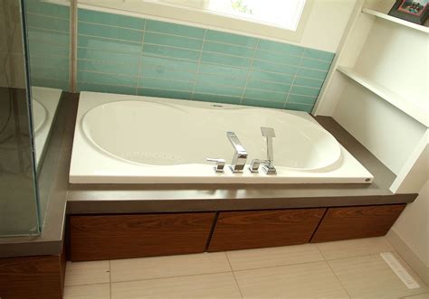 A decorative tile accent row tops the installation. Bath tub surround | Tub surround, Home, Corner bathtub