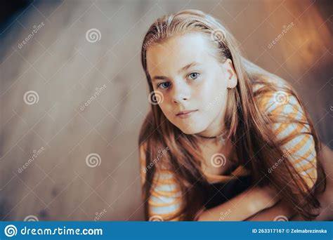 Teenage Girl Sitting On Floor And Looking At Camera Portrait With Copy