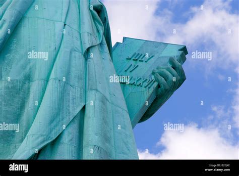 Statue Of Liberty Close Up On Arm Holding Book On Clear Blue Day Stock