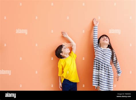 Cute Little Children Measuring Height Near Color Wall Stock Photo Alamy