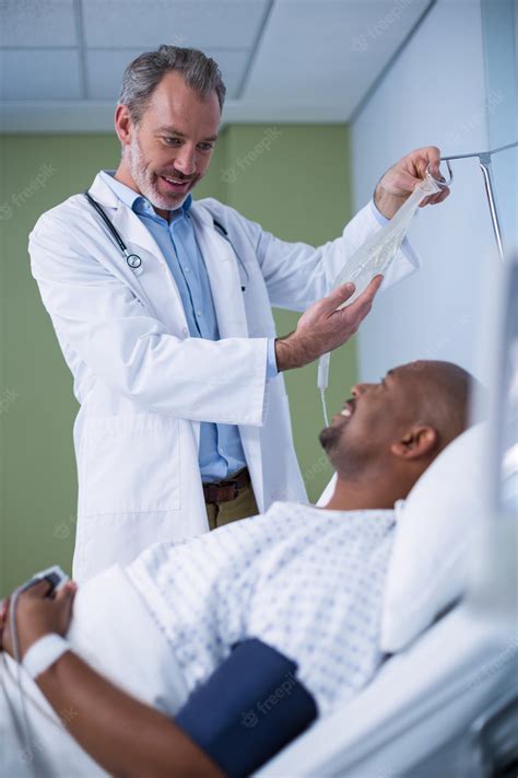 Premium Photo Doctor Interacting With Patient While Adjusting Iv Drip