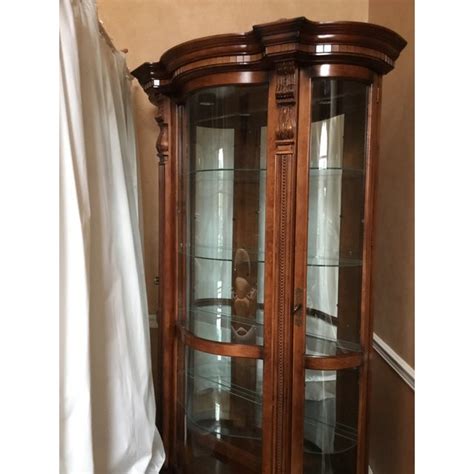 It features glass shelves, halogen lighten and mirrored back. Pulaski Curved Curio Cabinet | Chairish