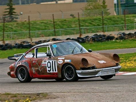 An Old Race Car Driving Around A Track