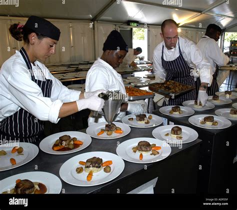 Chefs Working In Large Kitchen Preparing Banquet Dinner Stock Photo Alamy