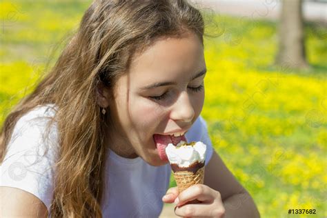 Beautiful Teen Girl Eating Ice Cream In A Waffle Cone Stock Photo