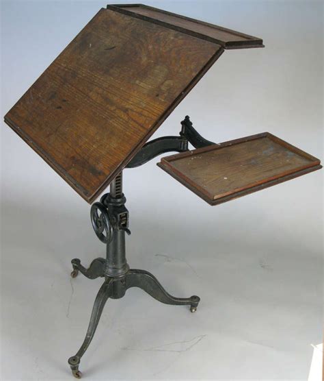 The iron base of our industrial crank drafting table is a feat in engineering with its functioning wheel and gear mechanisms that adjust the height and angle of the mango wood top. Antique Cast Iron Industrial Drafting Table at 1stdibs