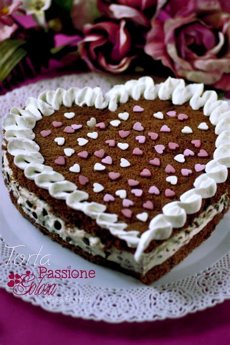 A Heart Shaped Cake Sitting On Top Of A White Plate Next To Pink