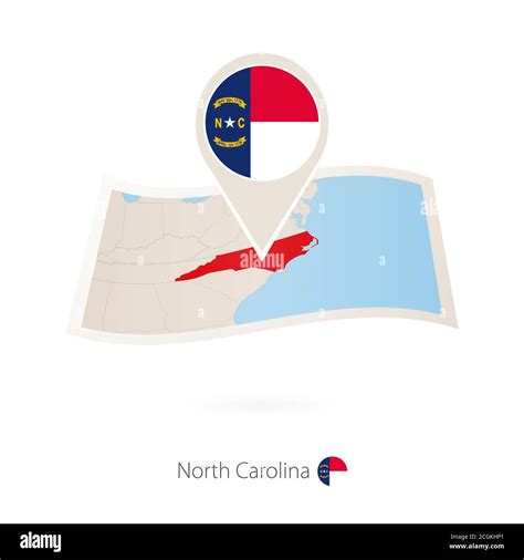 Folded Paper Map Of North Carolina Us State With Flag Pin Of North
