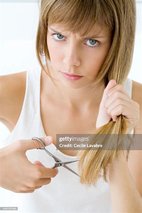 Teenage Girl Cutting Her Hair High Res Stock Photo Getty Images