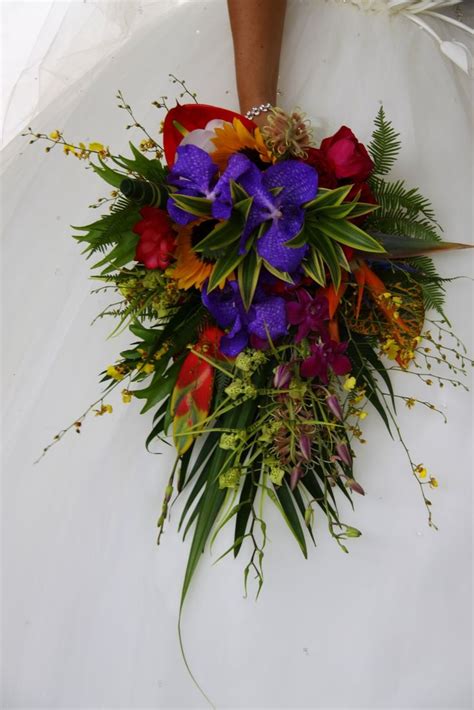 A Brides Bouquet With Purple And Red Flowers